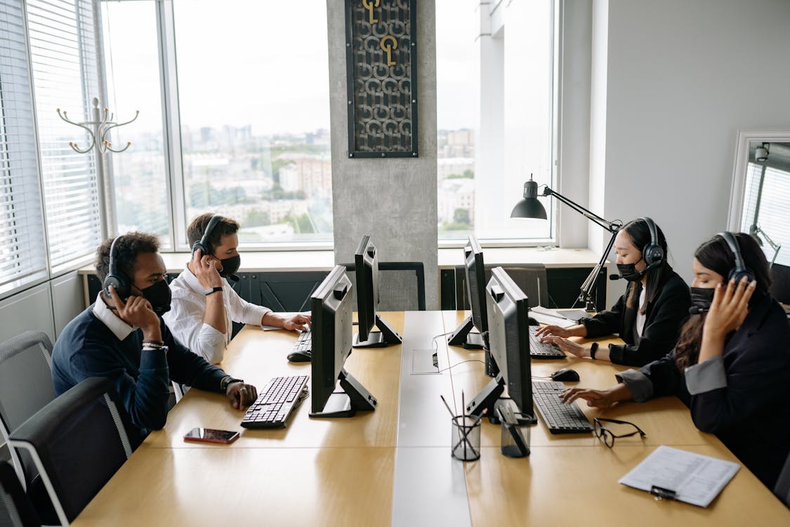 Free Group of Men and Women Working in the Office  Stock Photo