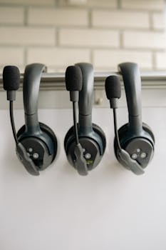 Close-up of three black headsets with microphones, ideal for audio production and communications.