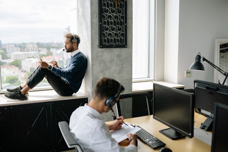 Men Using Computers In The Office