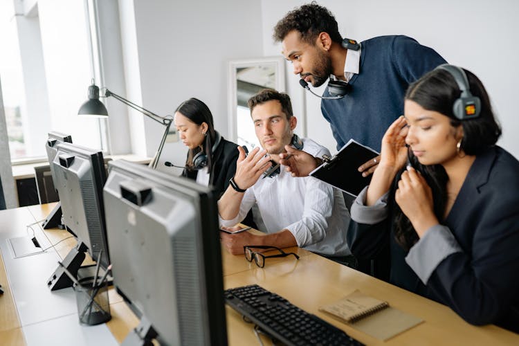 Men Looking At The Screen Of A Computer