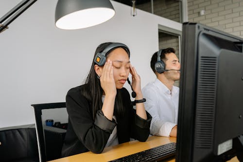 Free Exhausted Woman Sitting in Front of a Computer Stock Photo