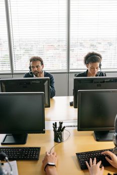 Colleagues in a modern call center working diligently with headsets.