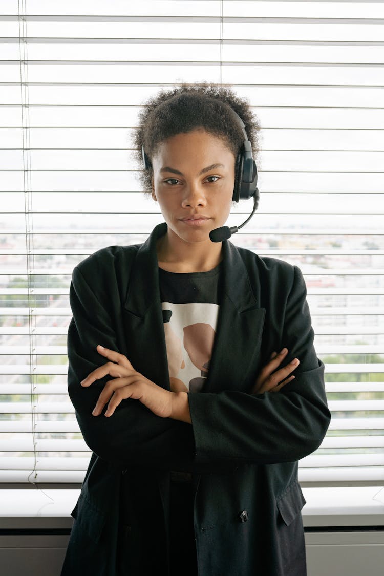 
A Woman Wearing A Headset And A Black Blazer