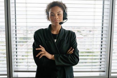 Woman with a Black Headset Posing with Her Arms Crossed