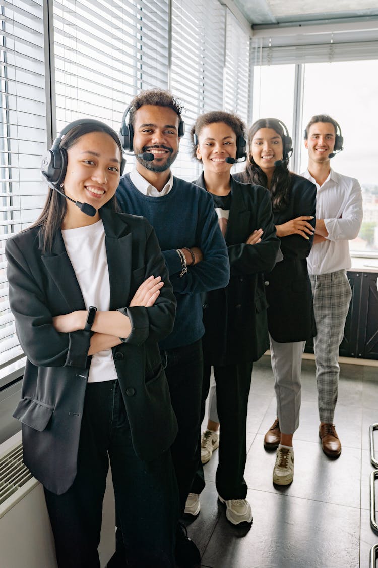 Colleagues Standing Together Wearing Headphones