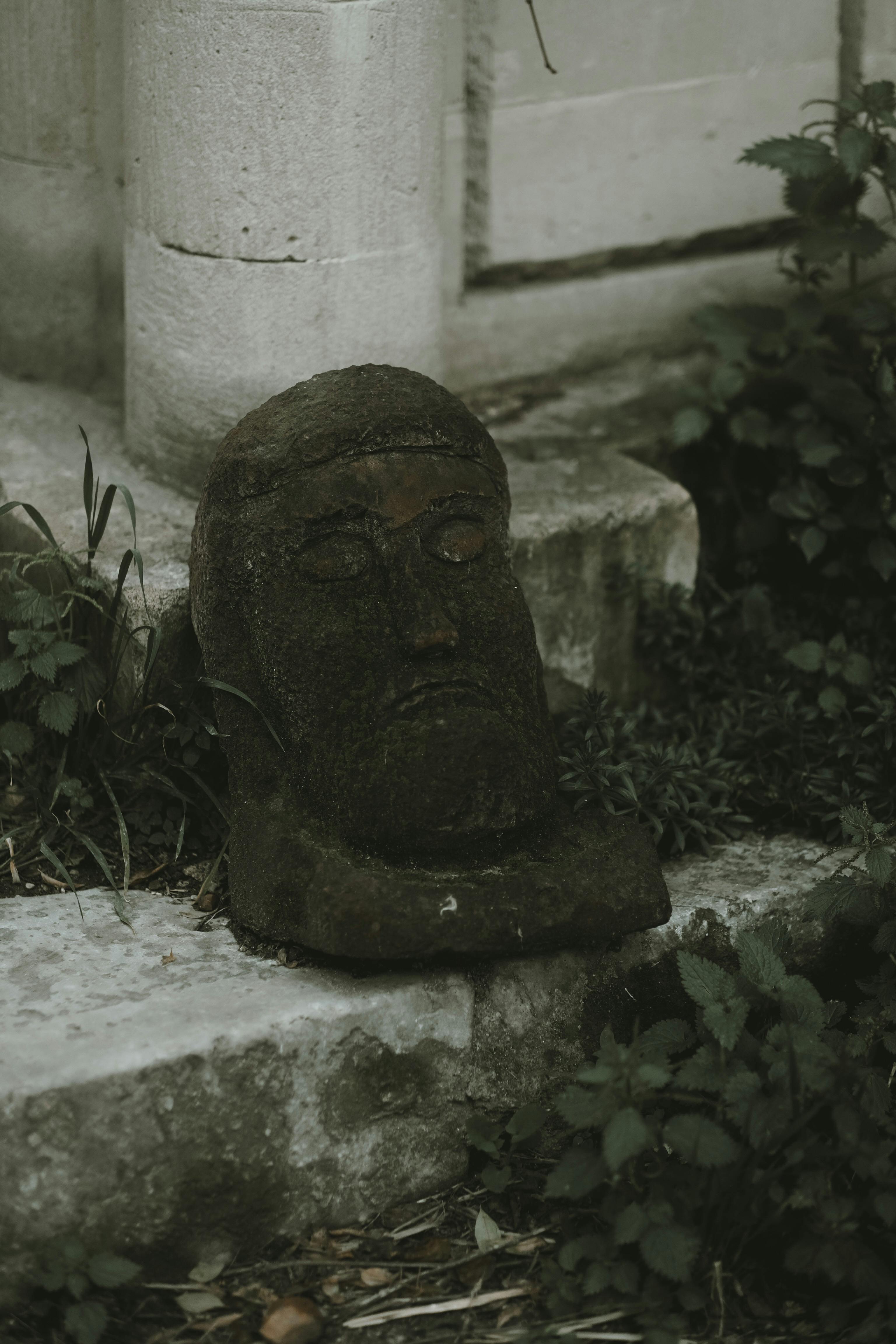 Black Head Sculpture on Concrete Block · Free Stock Photo