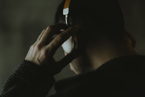 Man Wearing A Headset and Listening
