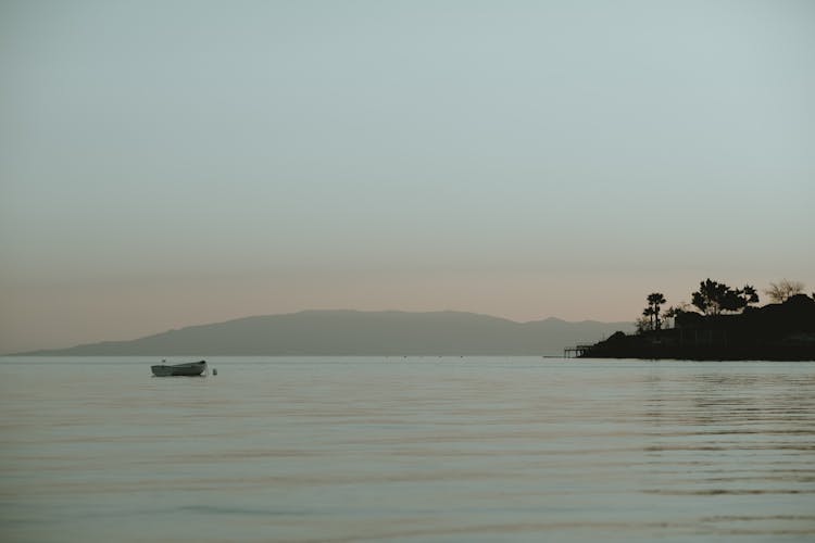 A Boat Anchored Near Coast 