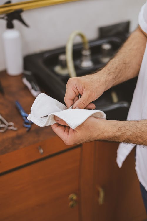 A Person Holding a Scissor