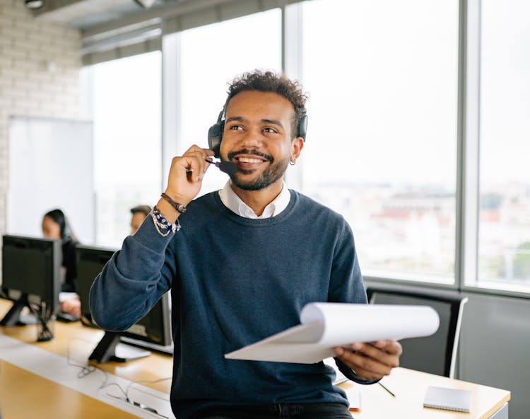 A Call Center Agent Holding A Clipboard