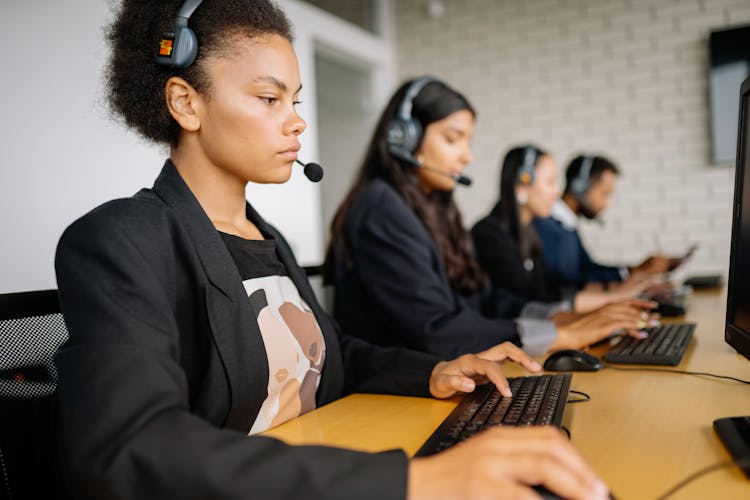 Four People Working In The Office