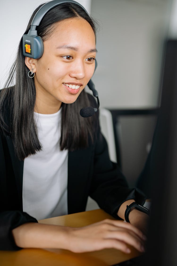 Woman In Black Blazer Wearing A Gray Headset