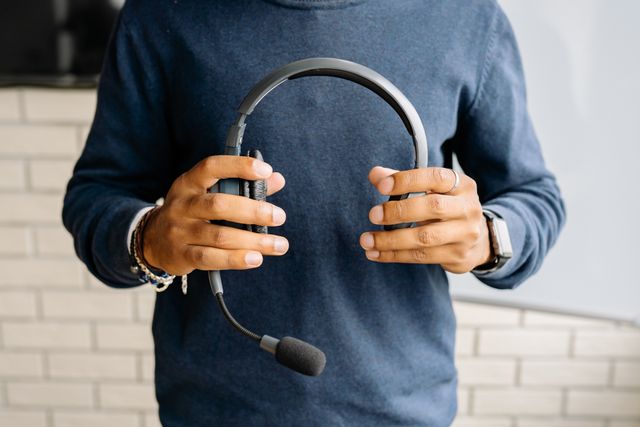 Person holding a headset for a conversation