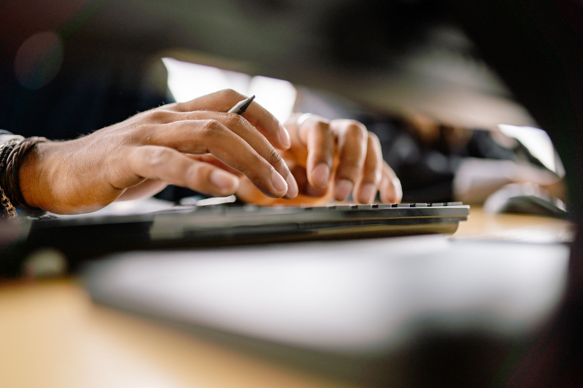 Close-Up Shot of Hands Typing on Keyboard