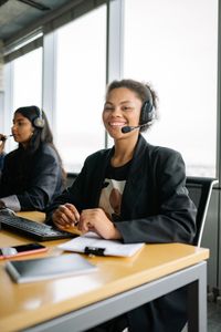Smiling support agent with headset — Yan Krukau on Pexels