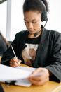 Woman in Black Blazer Using Black Headphones