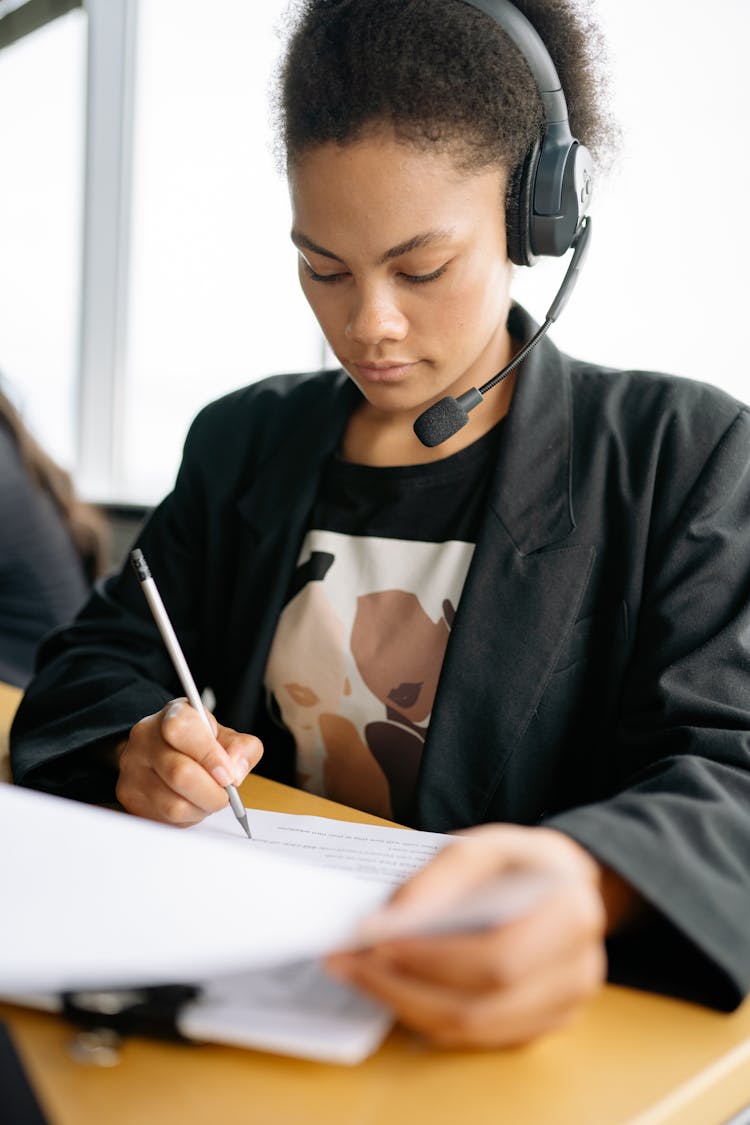 Woman In Black Blazer Using Black Headset