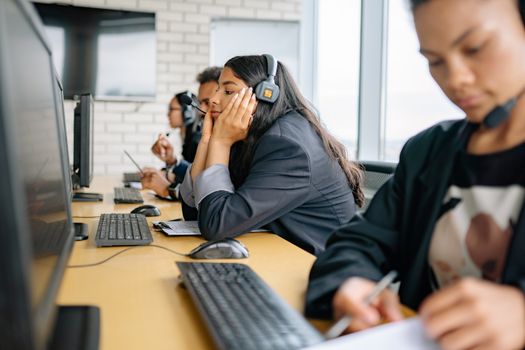 Professional call center team engaged in work at modern office.