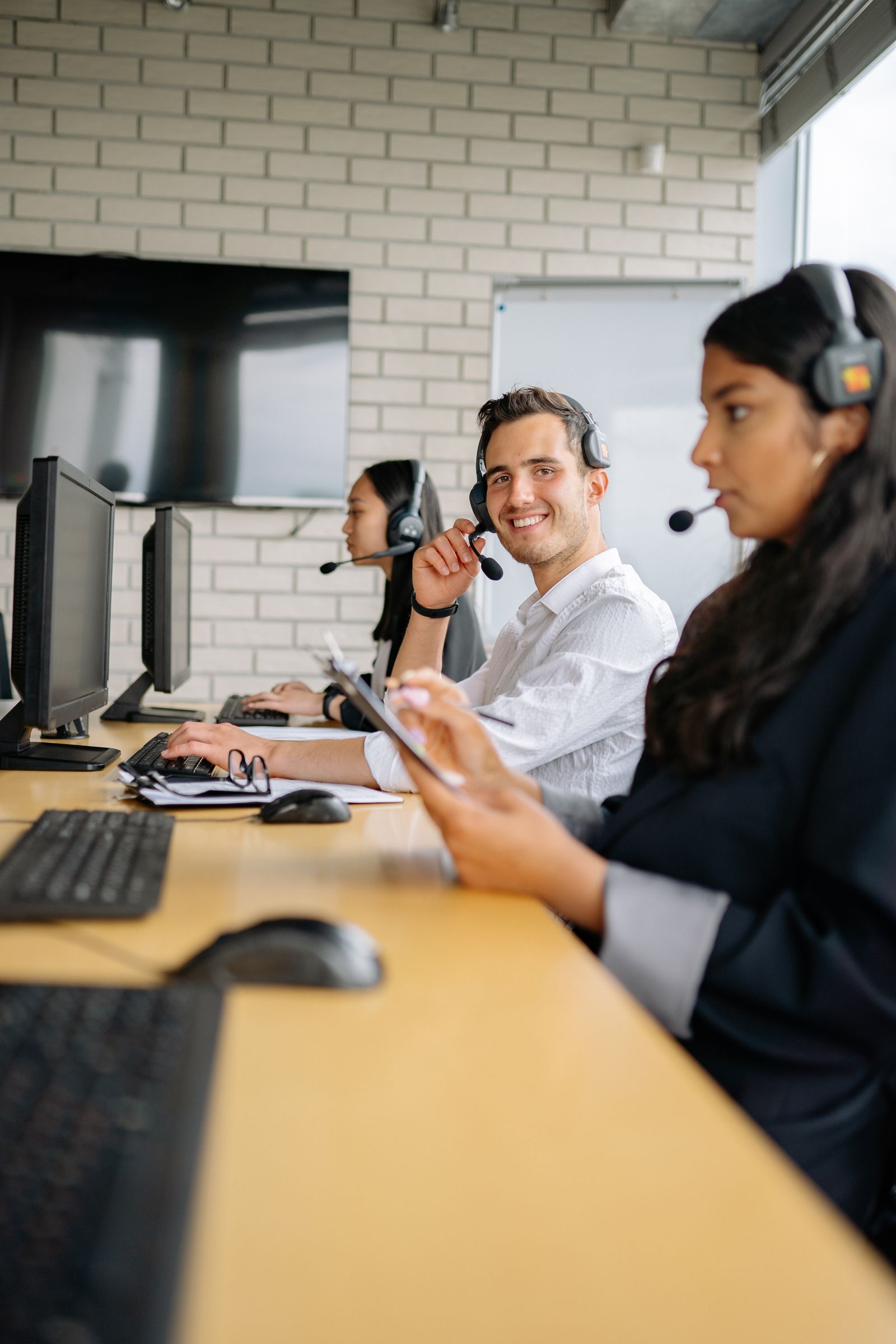 Three support advisers working together in an open-plan office
