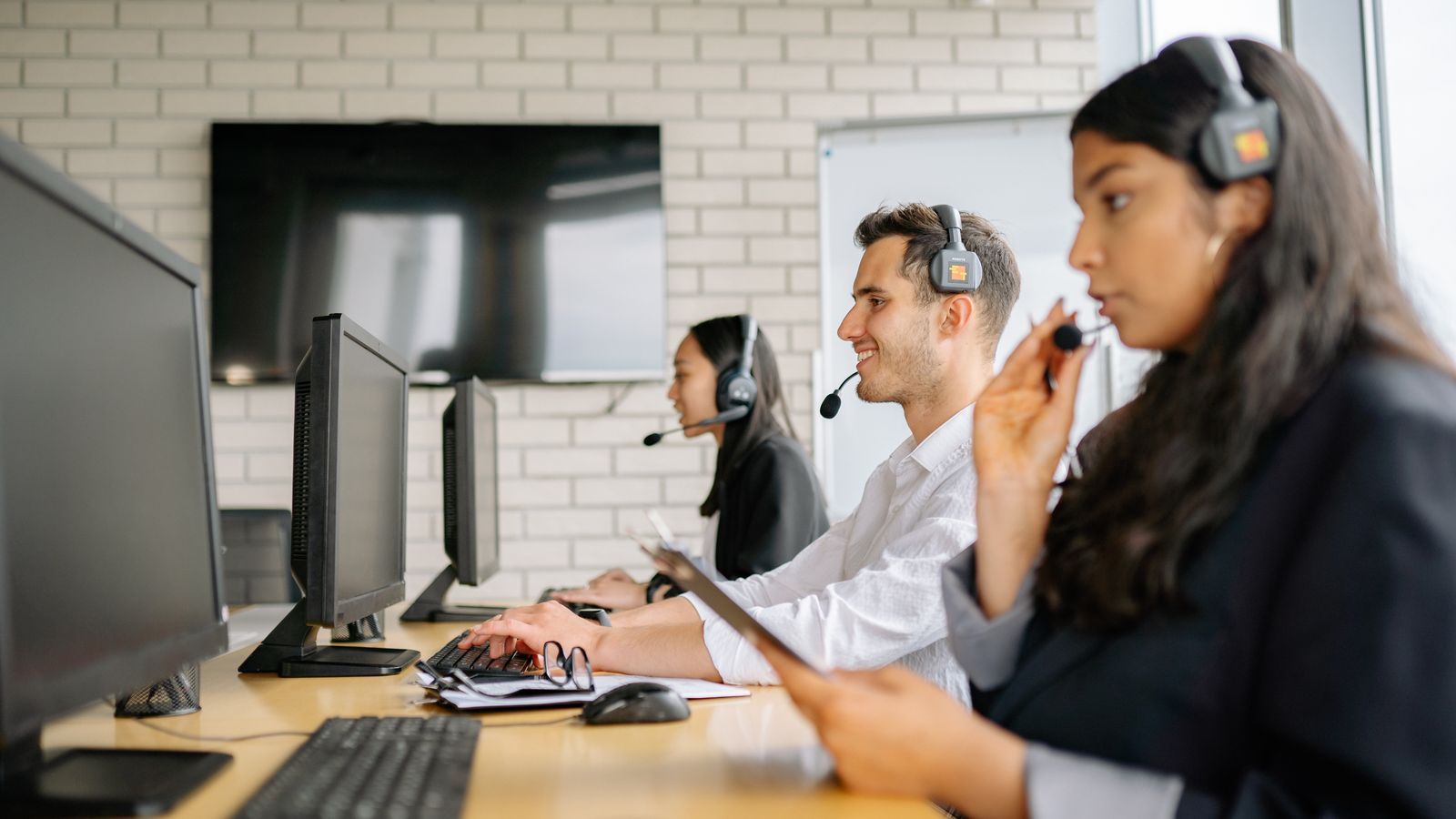 Logistics operations support center — agents with headsets at workstations