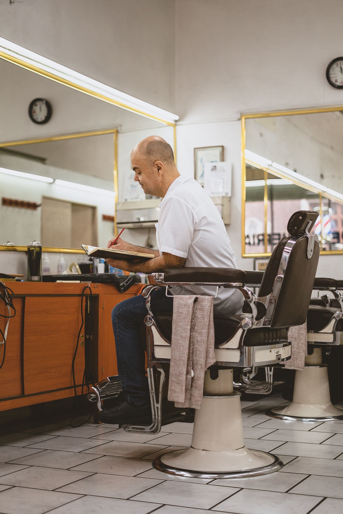 Barber doing his paperwork in the shop