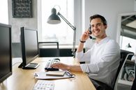 Man in White Dress Shirt Sitting at the Table