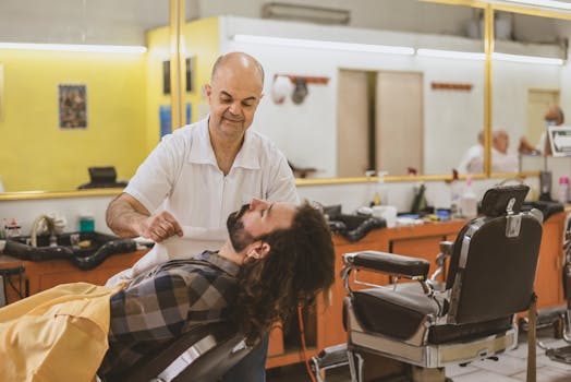 Experienced barber attentively shaving client's beard in a welcoming barber shop setting.