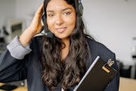 A Woman in Black Blazer Holding Her Head
