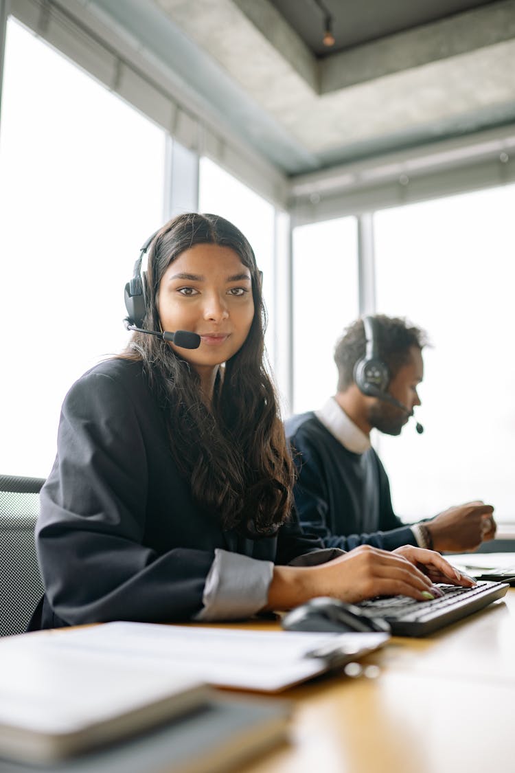 Woman Wearing Headphones While Working In The Office