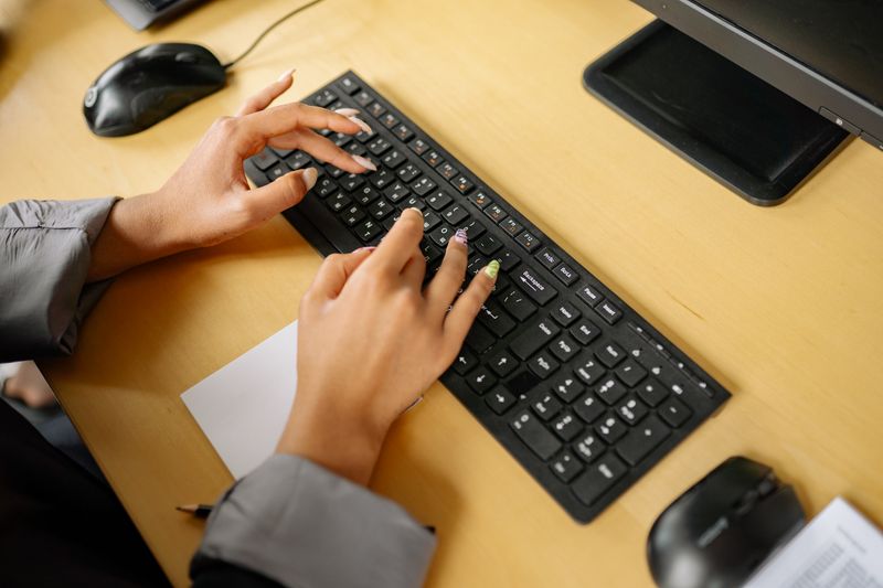 Customer support person at laptop responding to messages