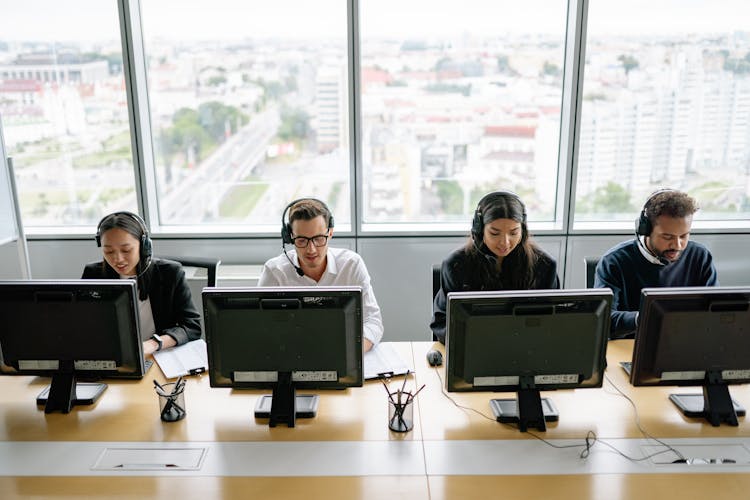 Four People Working In The Office