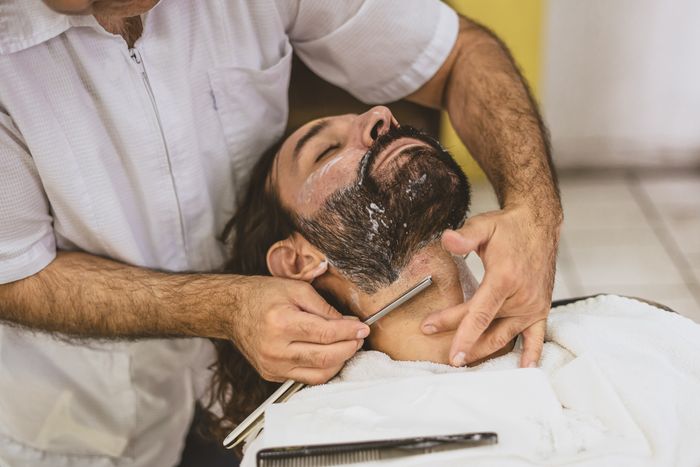 Barber using a straight razor