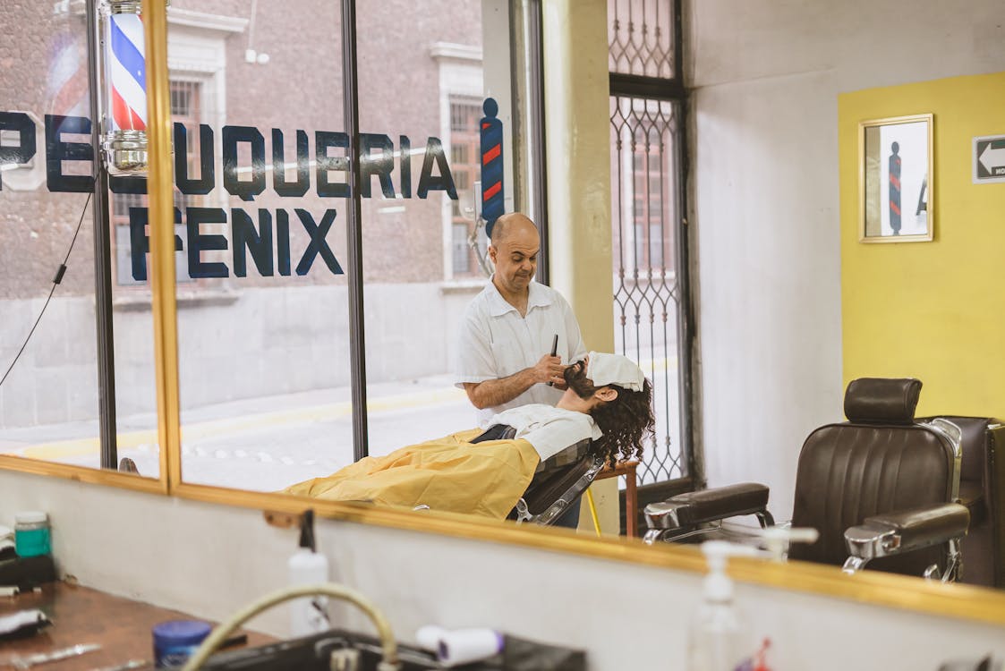 Barber presenting buzz cut consultation on tablet