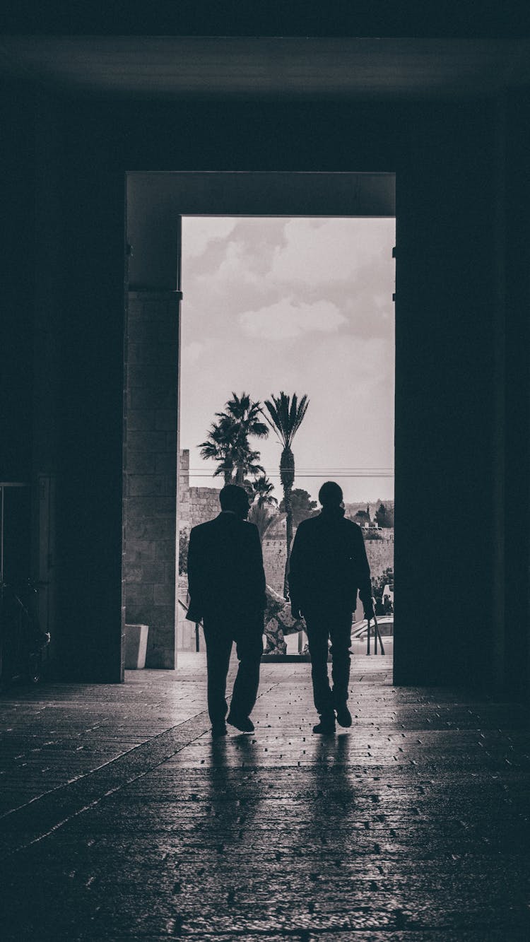 People Walking To Exit Of Building