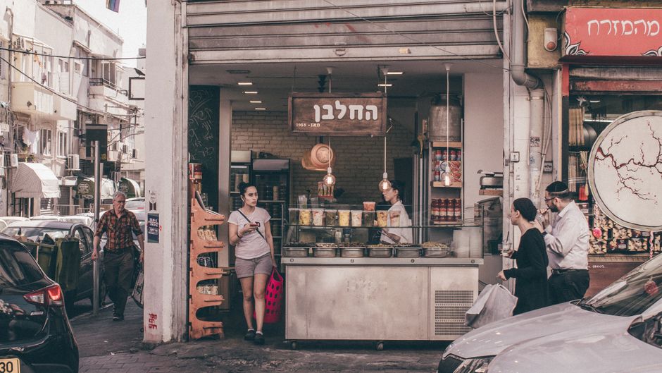 A taxi driving on a busy street in Tel Aviv, Israel, representing ride-hailing