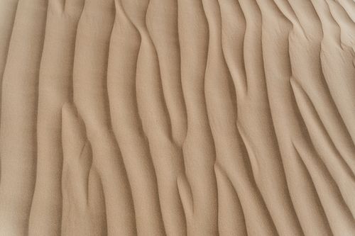 Free Close-up view of textured sand dunes showcasing natural patterns and arid beauty. Stock Photo