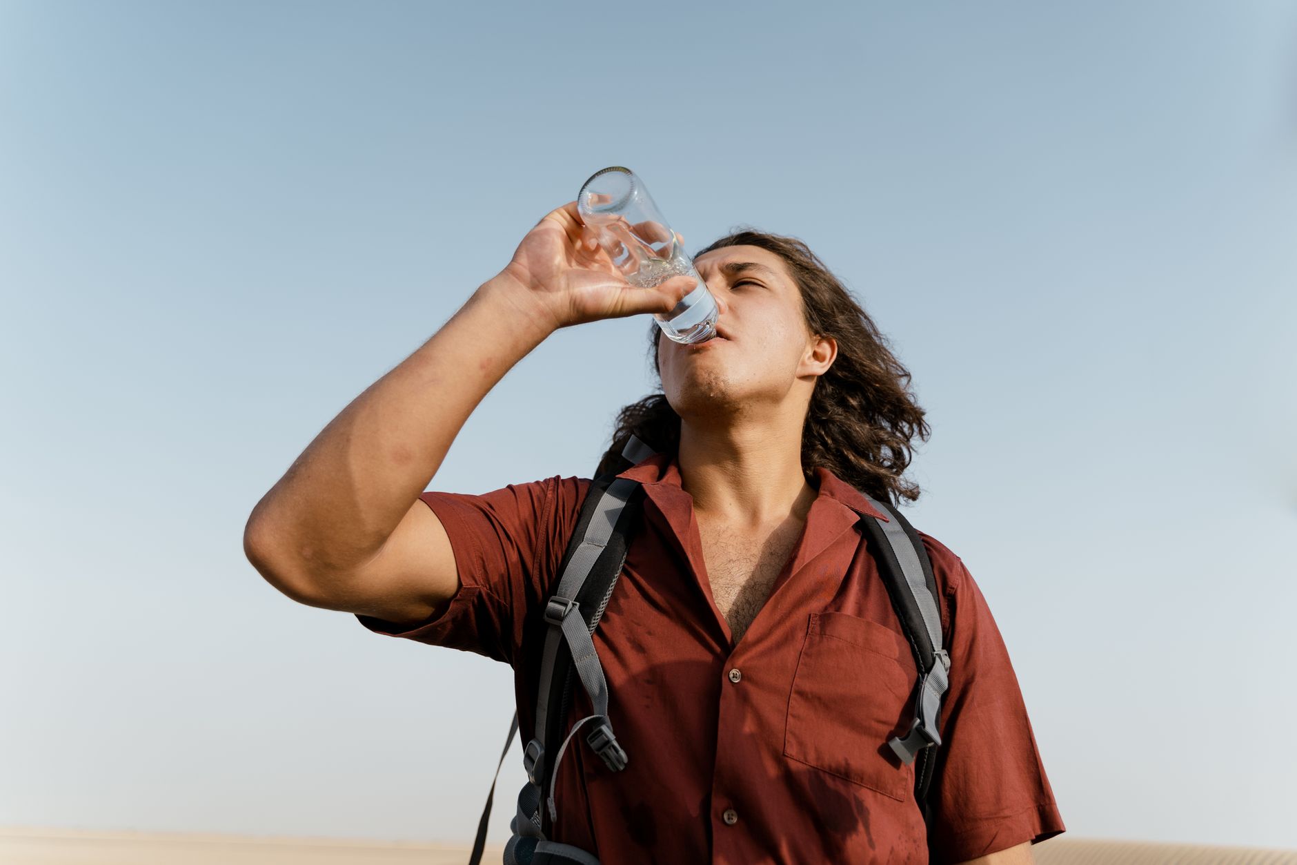 hiker drinking water trail