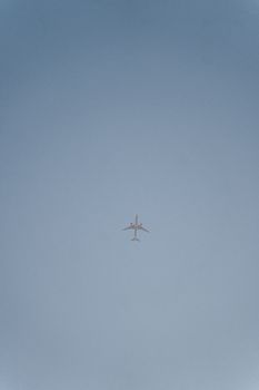 A low-angle shot of an airplane against a clear blue sky, capturing flight in simplicity.