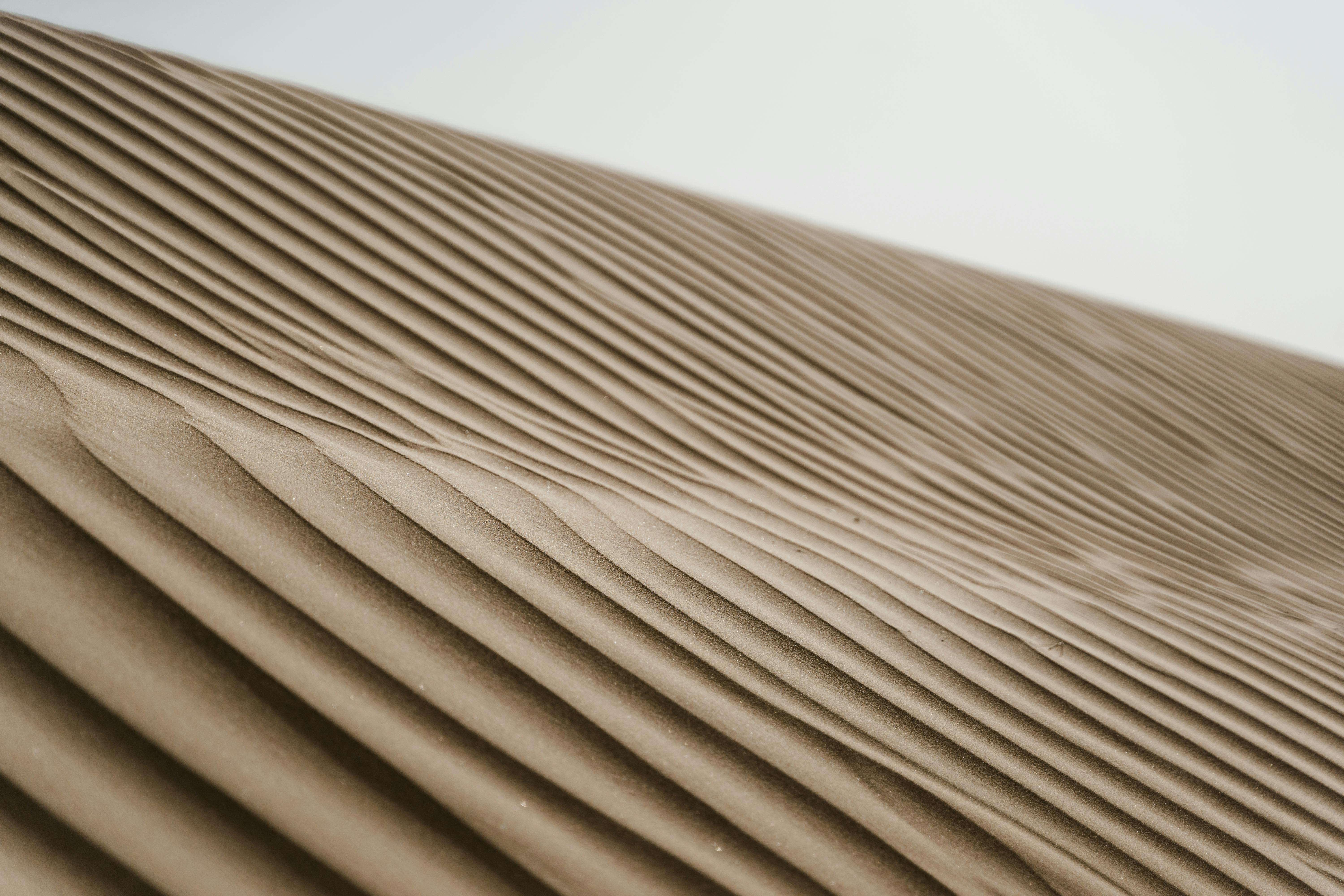 Explore the mesmerizing patterns of vast sand dunes in this stunning desert landscape.