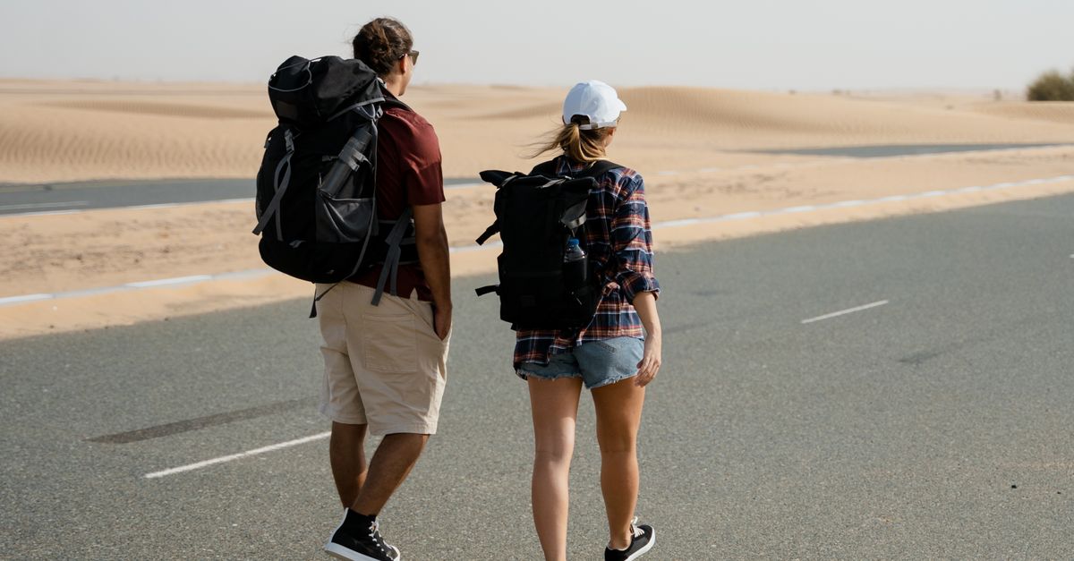 Walk With Rucksack Man and Woman Walking on the Road while Carrying Their Rucksack Bag ...