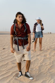 Two young adults exploring a sunlit desert, embodying adventure and exploration.