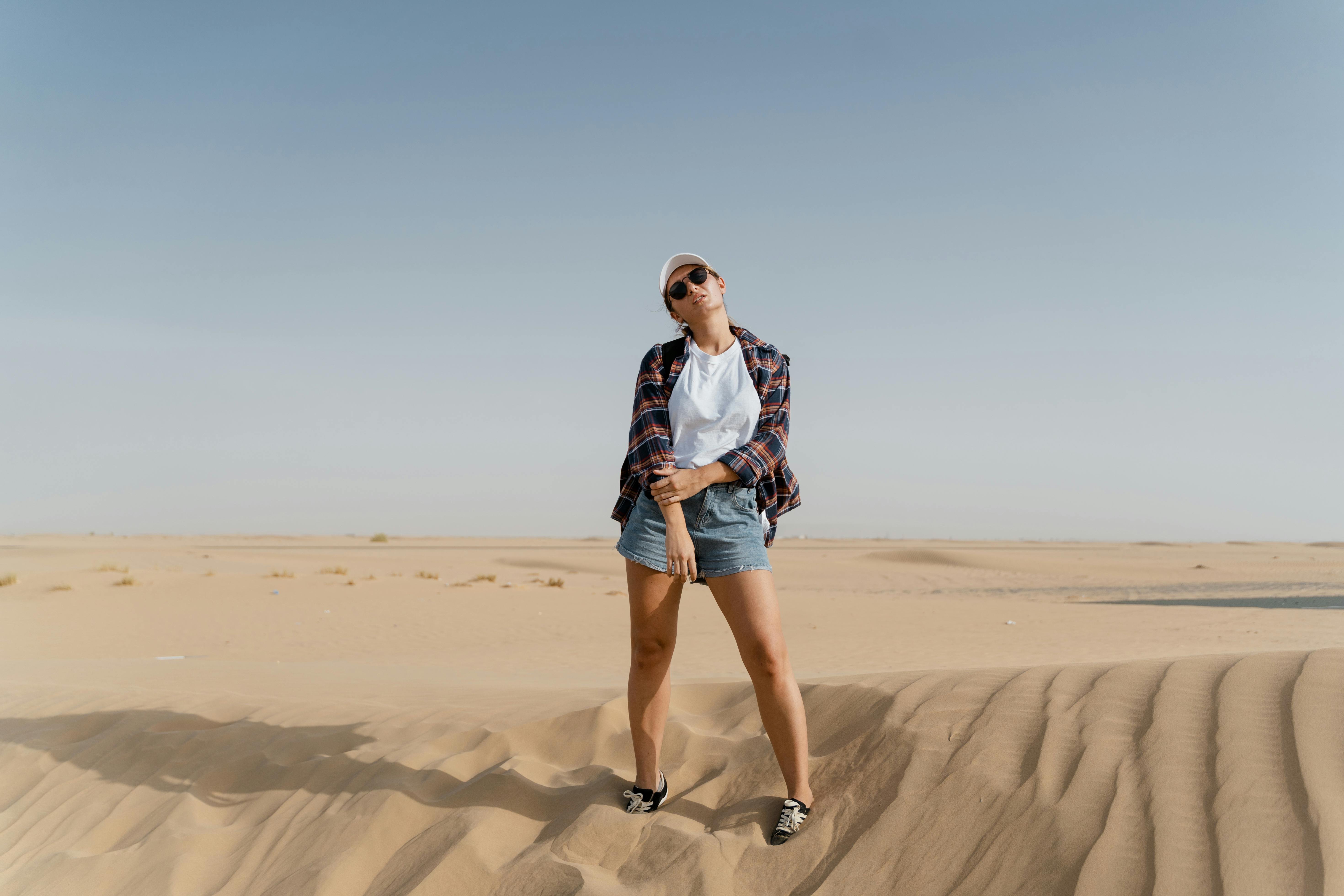 Beautiful Woman Wearing Denim Shorts And Top Outdoors In Desert
