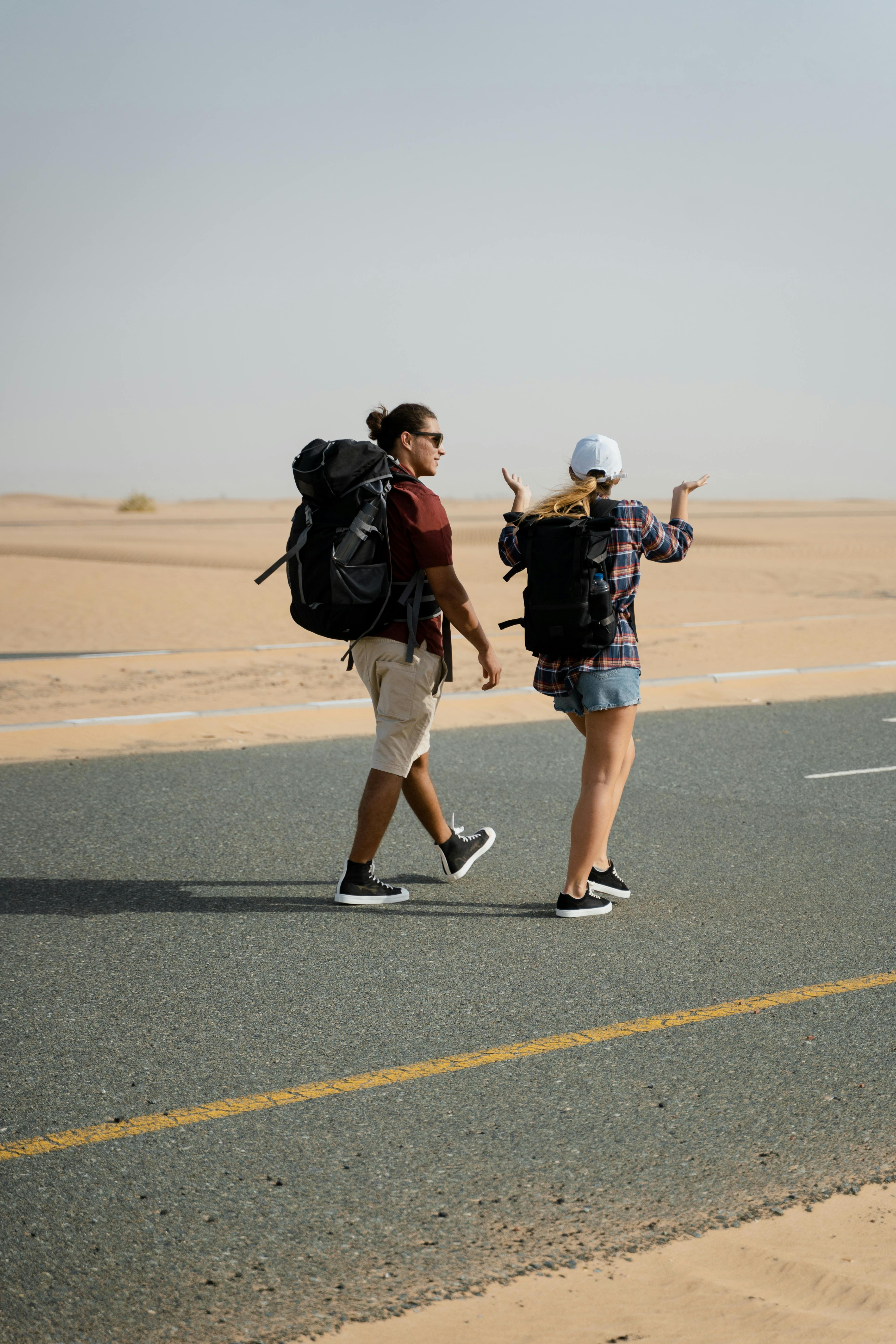 a couple walking together on a desert road