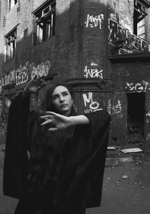 A Woman Standing Outside an Abandoned Building