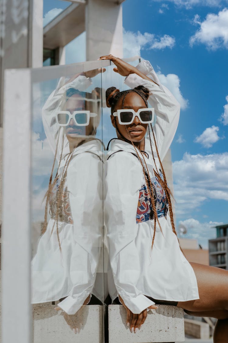 Woman With White Sunglasses Posing Near Glass