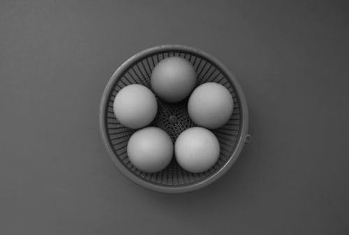 Free Close-Up Shot of Eggs in a Mesh Basket Stock Photo