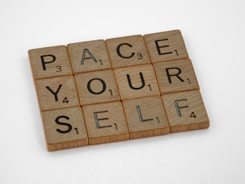 Close-Up Shot of Scrabble Tiles on a Gray Surface