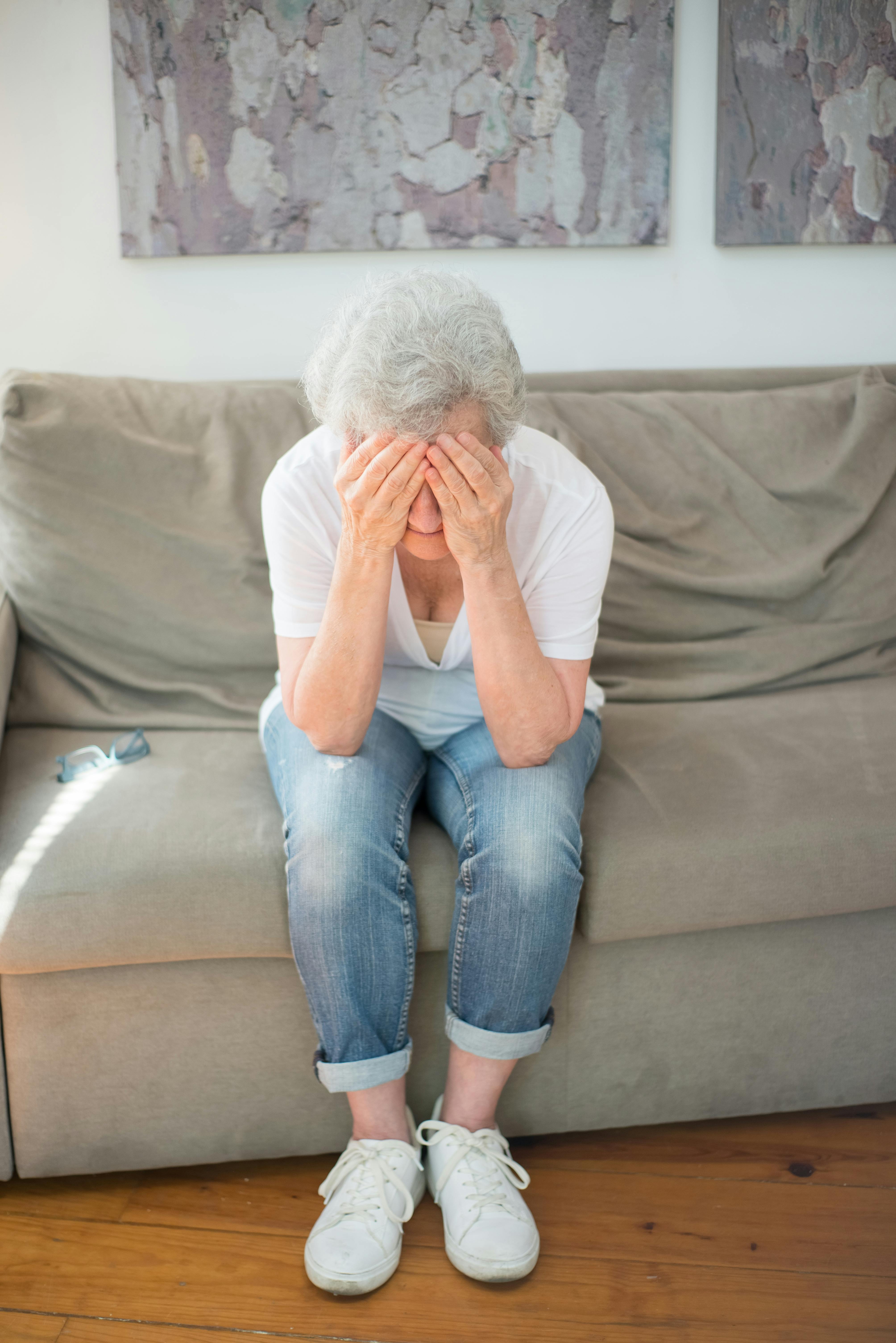 elderly woman sitting on a couch