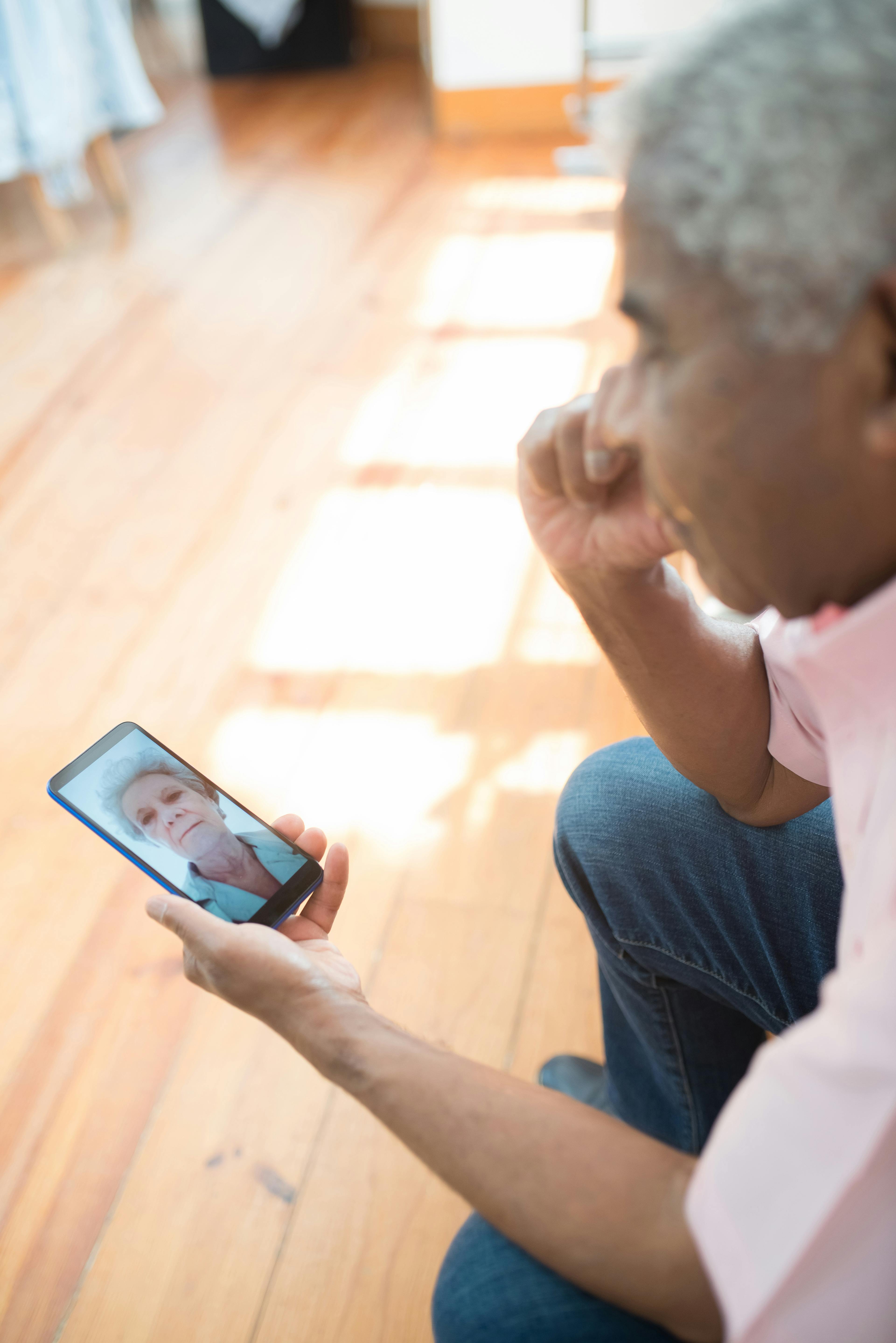 an elderly couple communicating thru video call