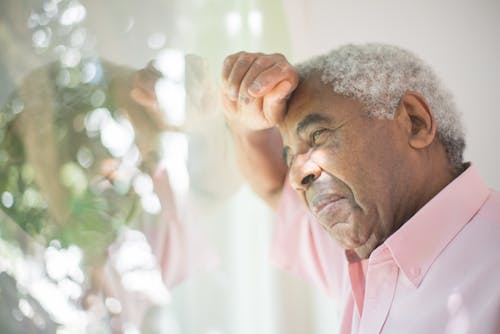 Elderly Man in Pink Button Up Shirt Looking Sad 